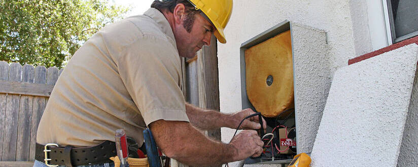 Image of an HVACR technician repairing equipment